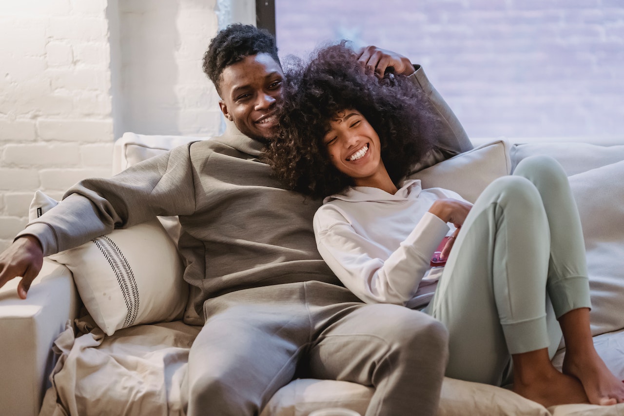 happy couple on couch at home